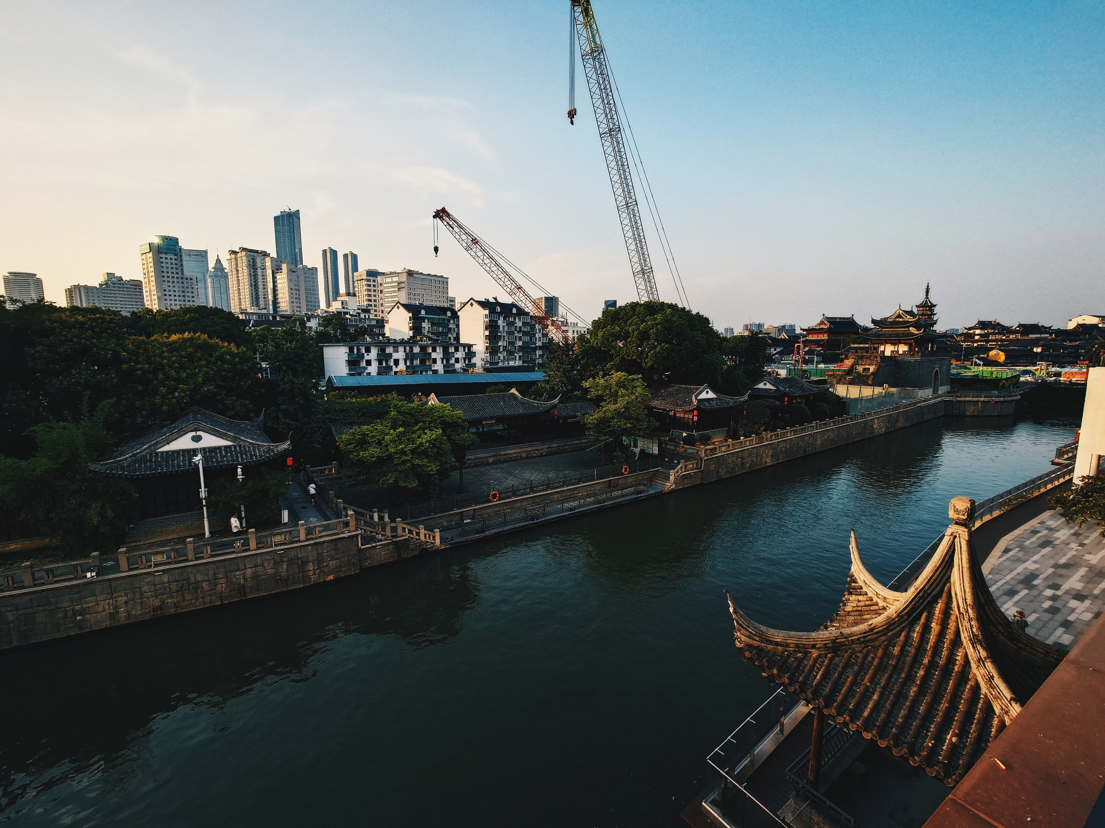 Canal at afternoon with city buildings and pagodas in background. From patio of Red Lion bar.