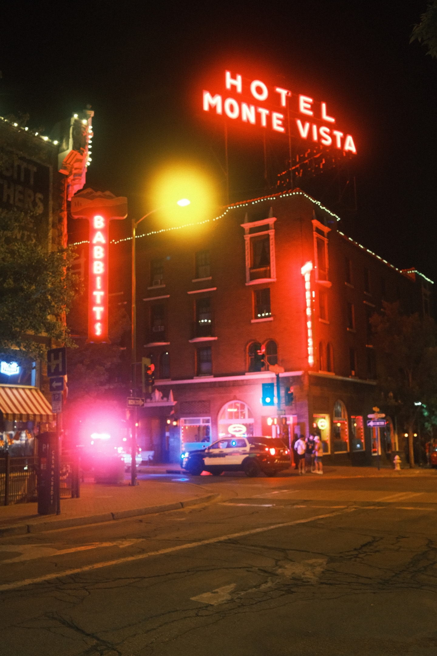 Hotel Monte Vista illuminated at night with its famous signage lit up.